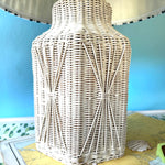 a close up of a white rattan vintage lamp