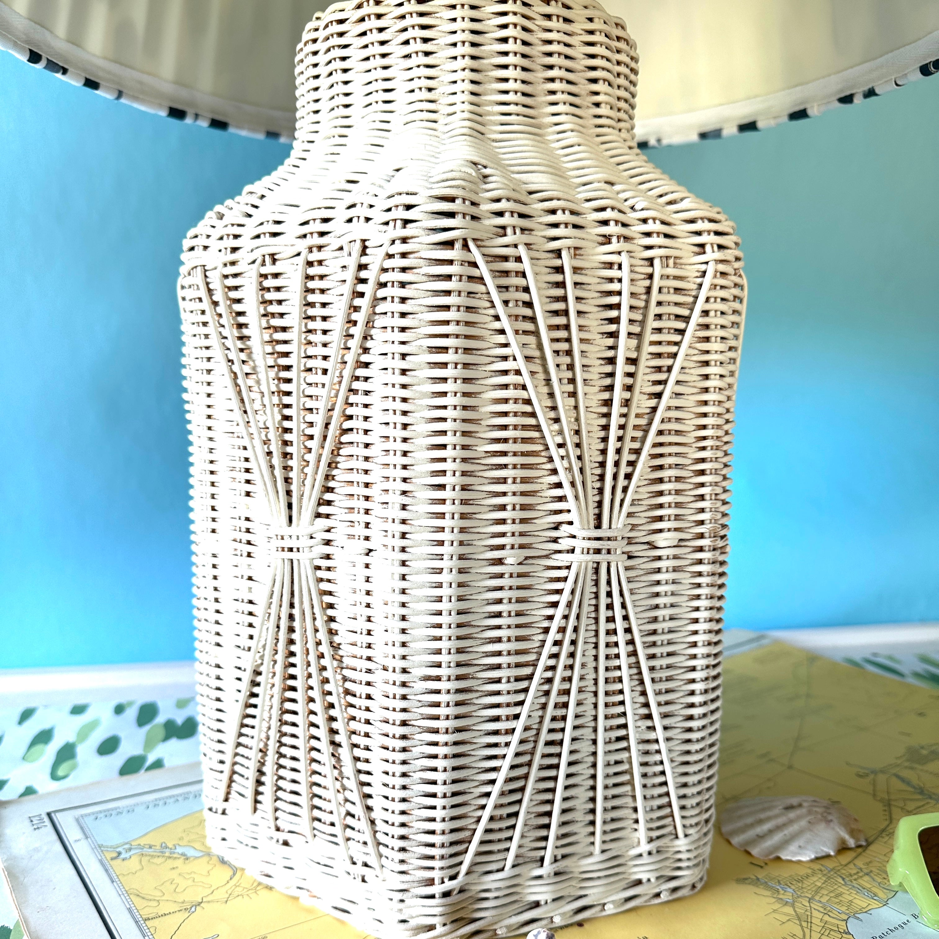 a close up of a white rattan vintage lamp