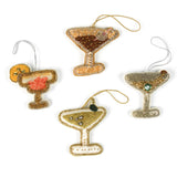 Set of four cocktail-themed Christmas ornaments on a white background