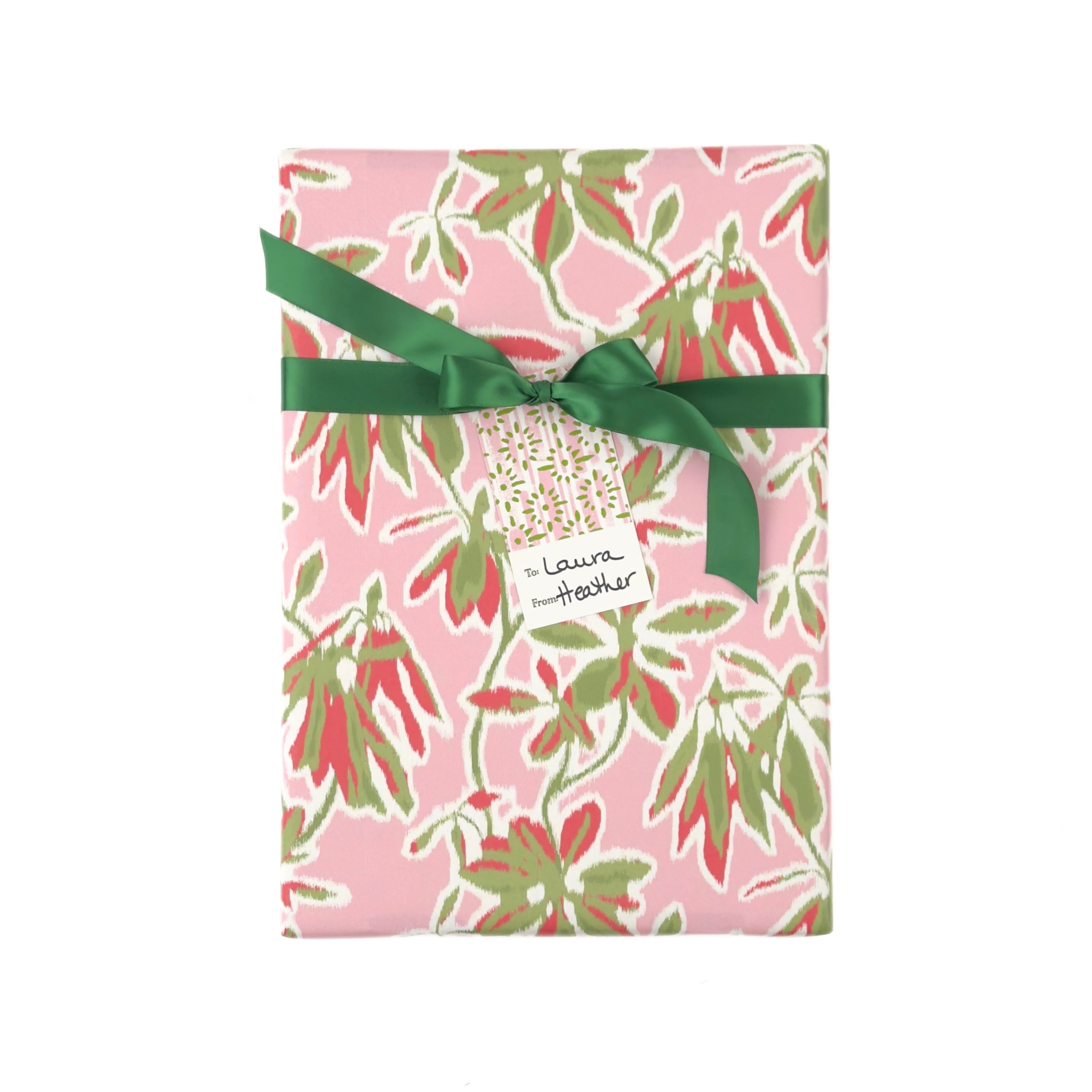 Elegant botanical gift wrap featuring lush green foliage, coral floral accents, and soft pink backgrounds.