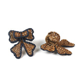 rattan bow napkin rings with blue outlines on a white background. 