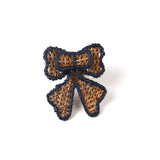 rattan bow napkin ring with a blue outline on a white background. 