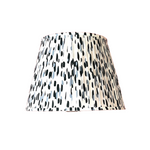 a blue and white pleated lampshade made from a brushtroke motif pattern called Club House by Madcap cottage