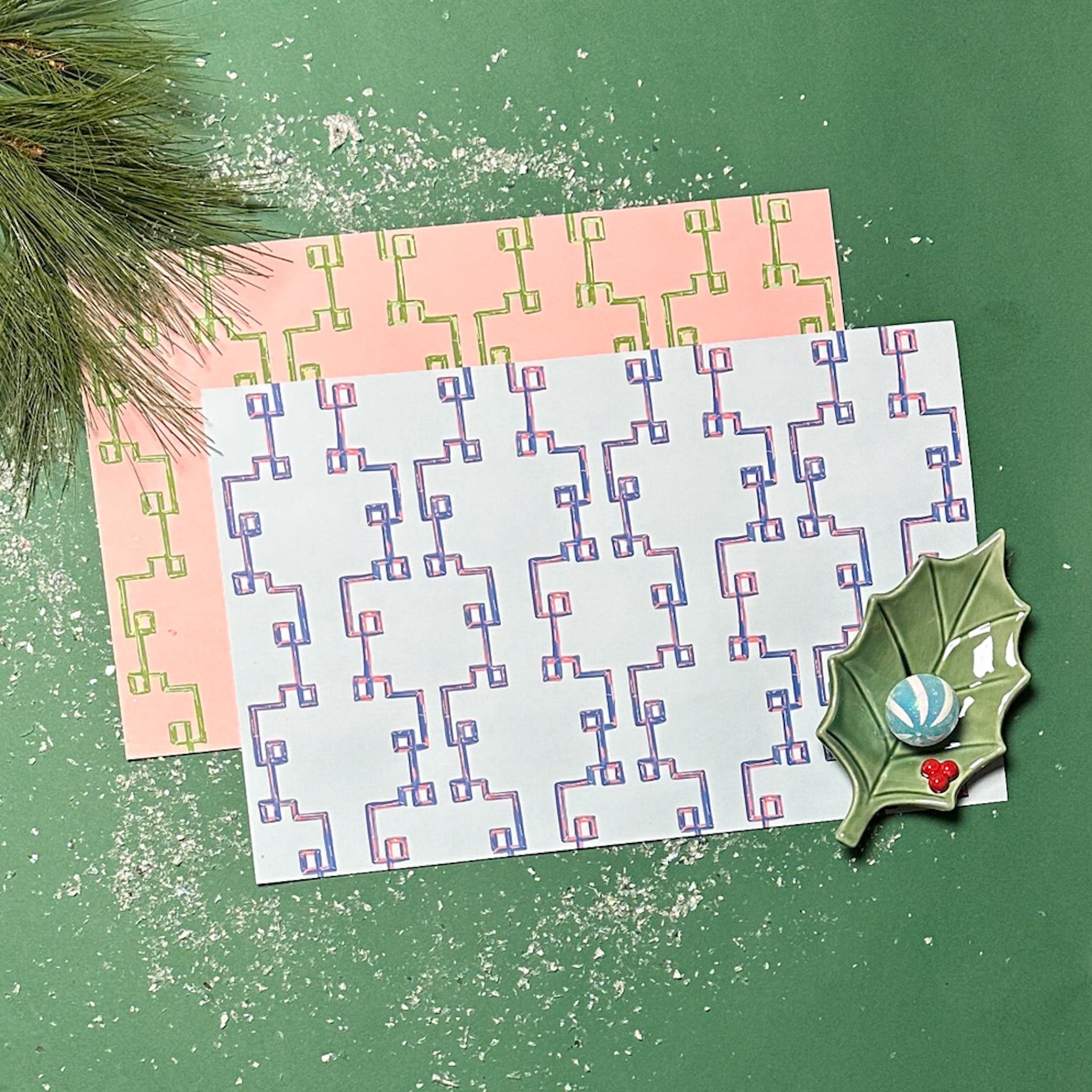 blue and pink bamboo lattice paper placemats on green background table setting