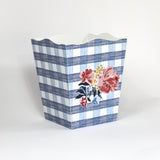 a blue floral wastepaper basket in a gingham pattern with a central floral motif from madcap cottage. 