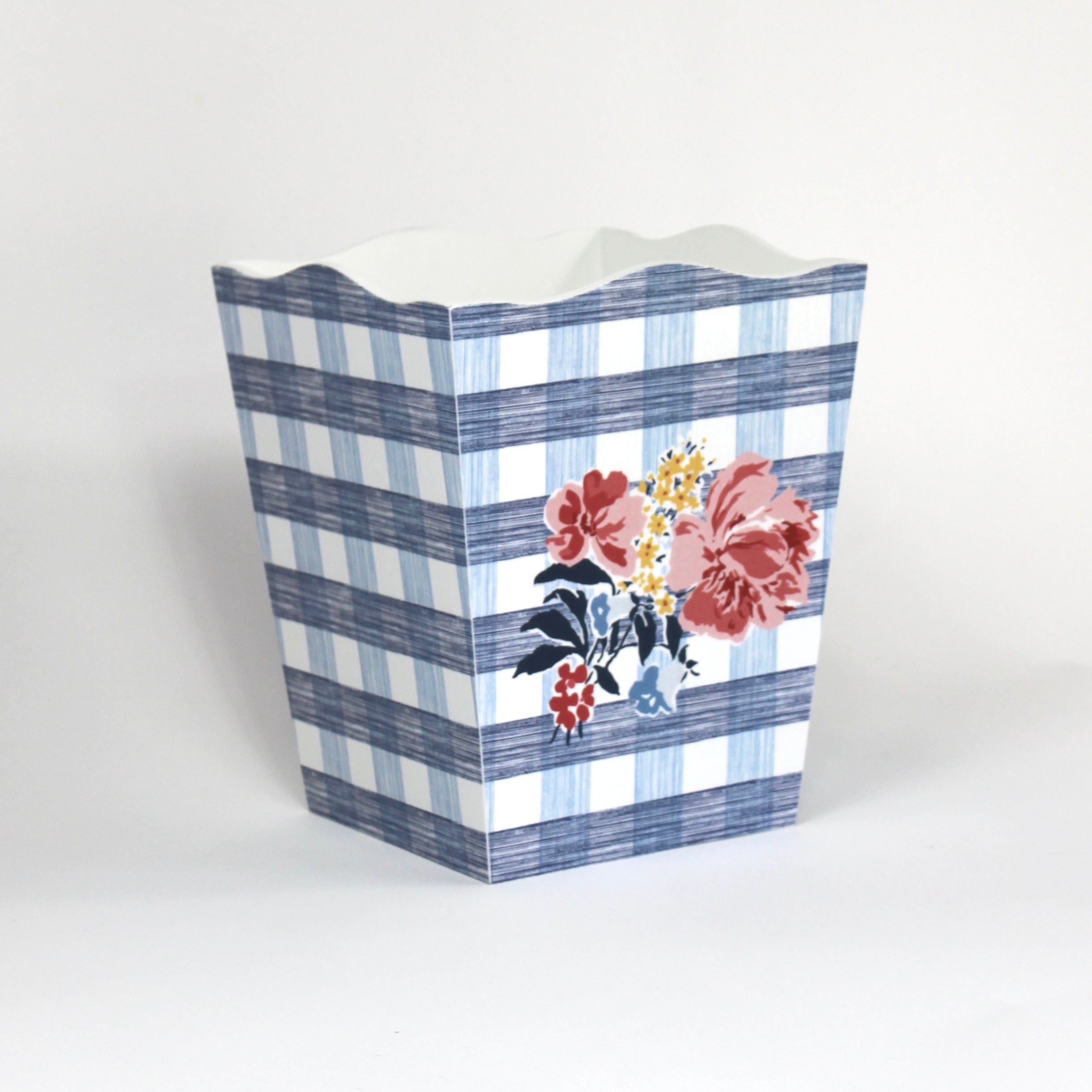 a blue floral wastepaper basket in a gingham pattern with a central floral motif from madcap cottage. 