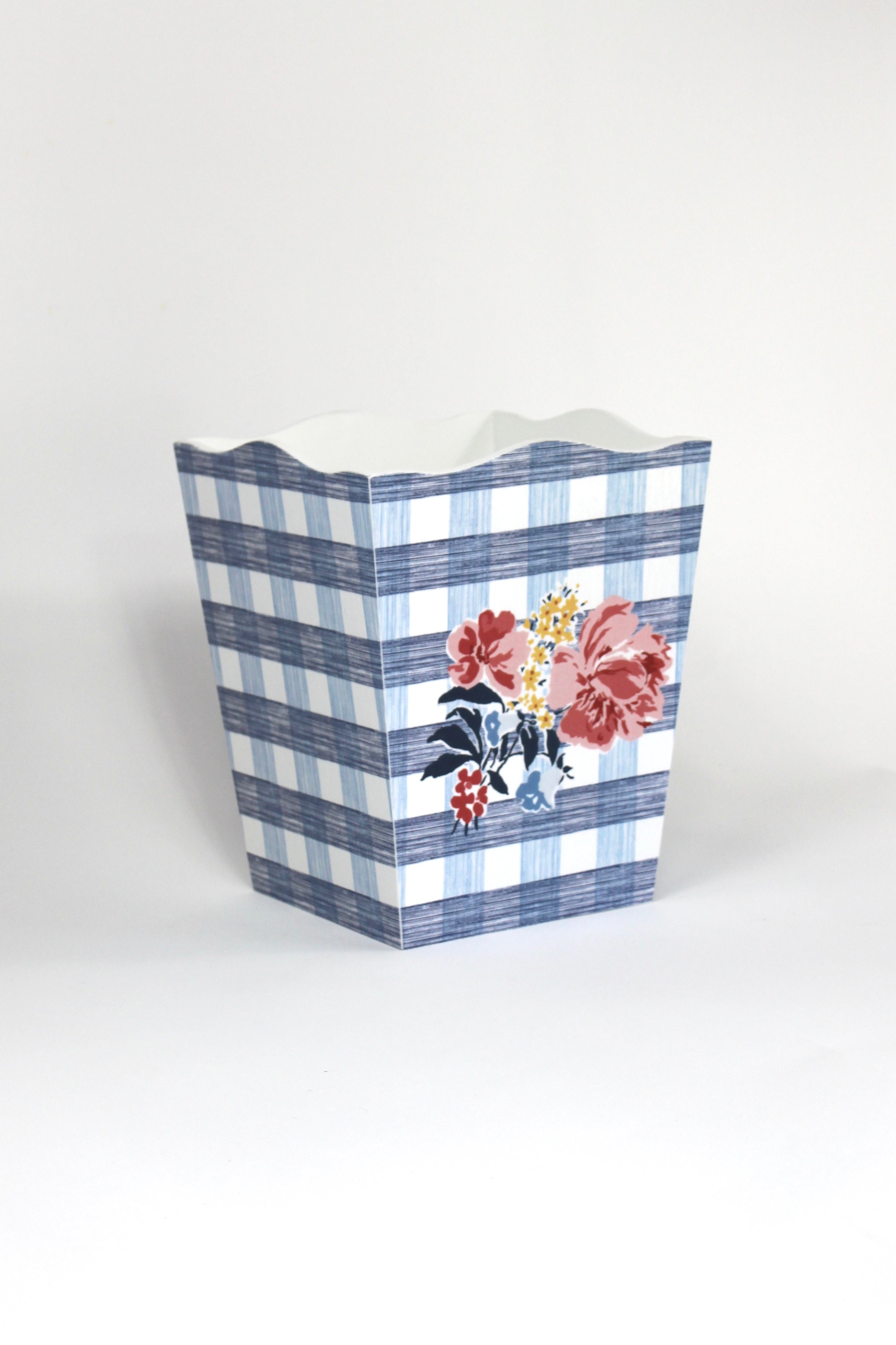 a blue floral wastepaper basket in a gingham pattern with a central floral motif from madcap cottage. 