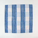 Cloth napkin laid flat with a vertical blue and white striped pattern.