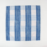 Cloth napkin laid flat with a vertical blue and white striped pattern.