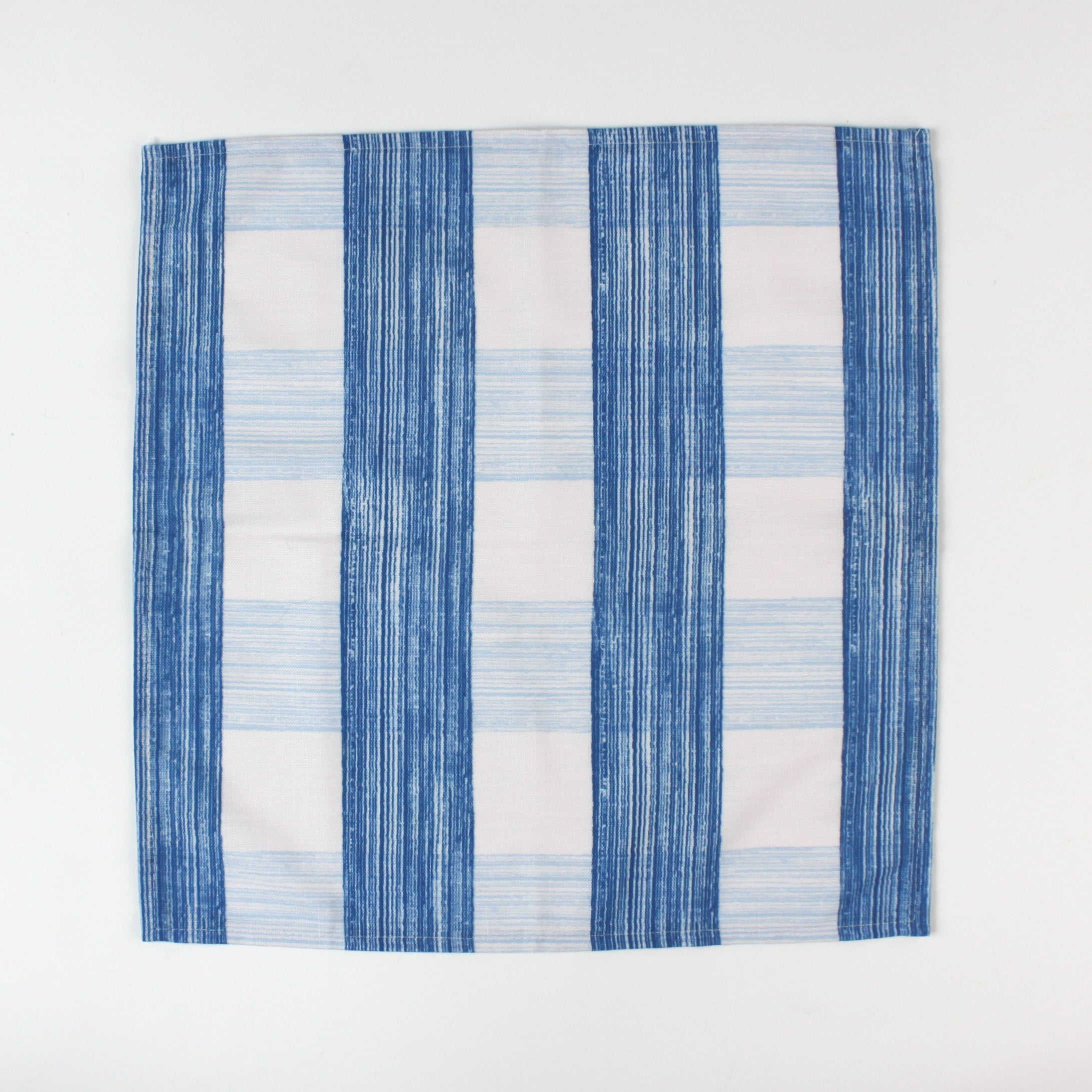 Cloth napkin laid flat with a vertical blue and white striped pattern.