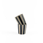 Two blue striped ceramic cups stacked on a white background