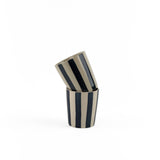 Two blue striped ceramic cups stacked on a white background