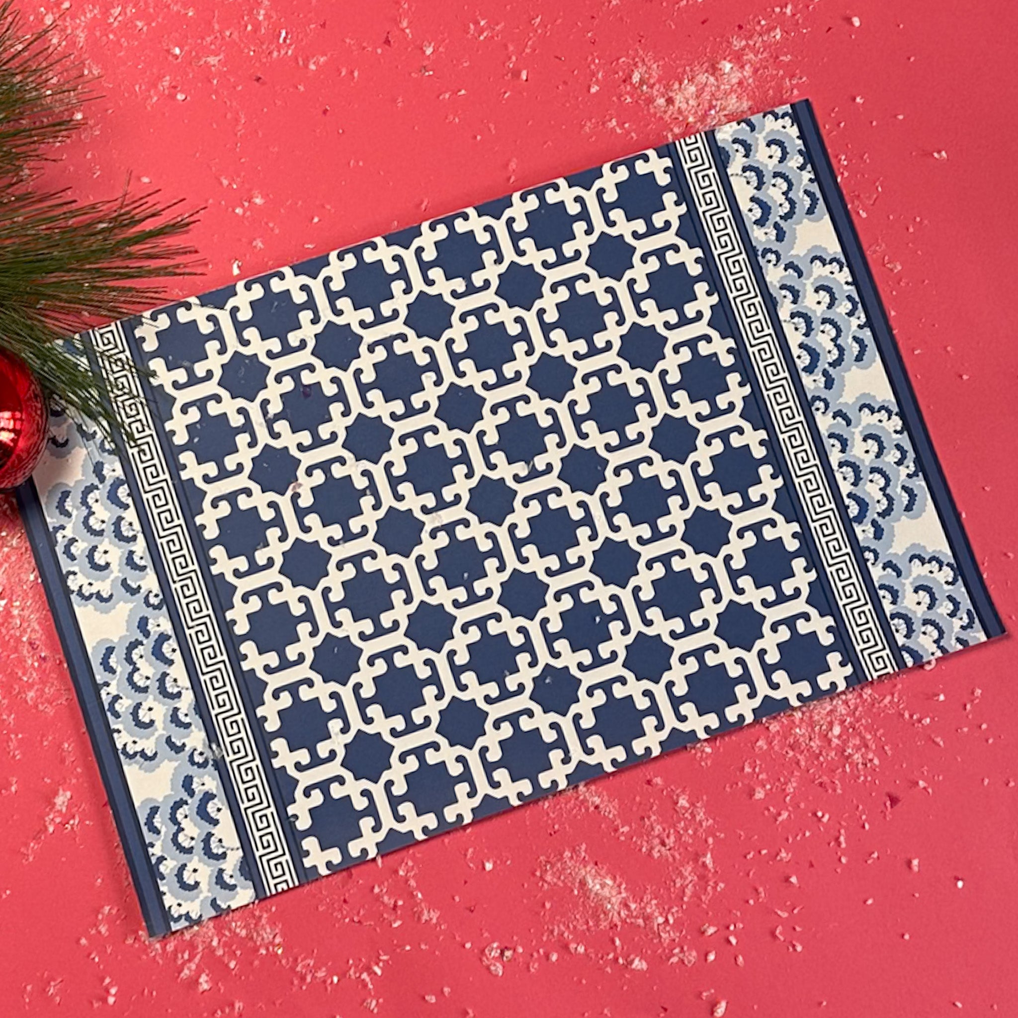 blue lattice patterned paper placemat with decorative border on table setting