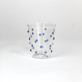 Clear glass with blue dots on a white background