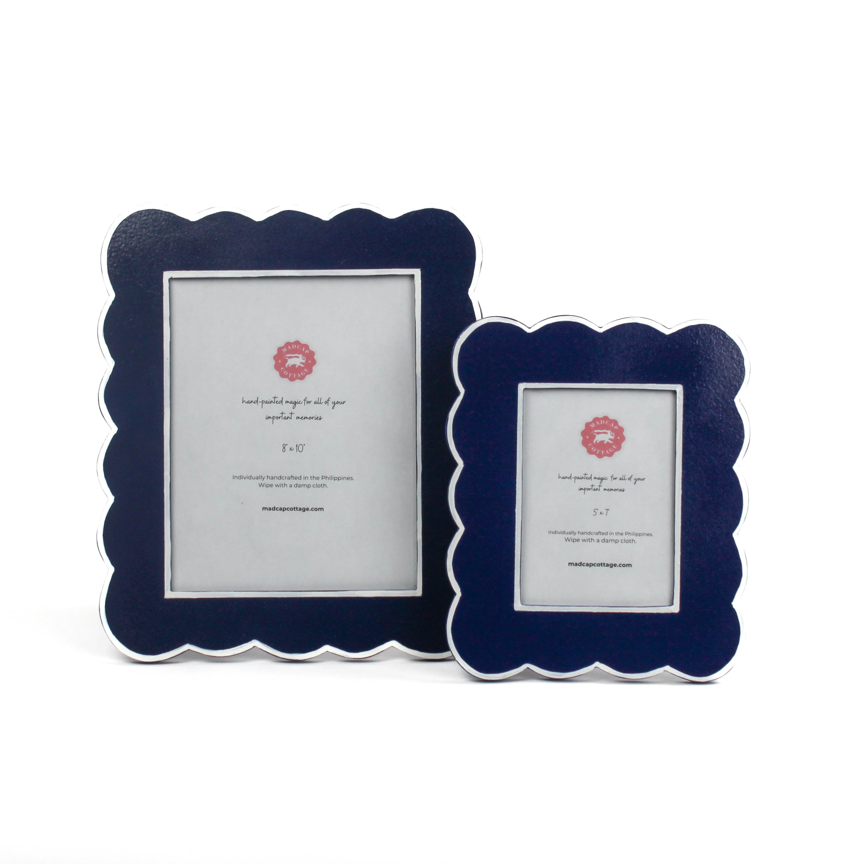 Two blue scalloped photo frames on a white background
