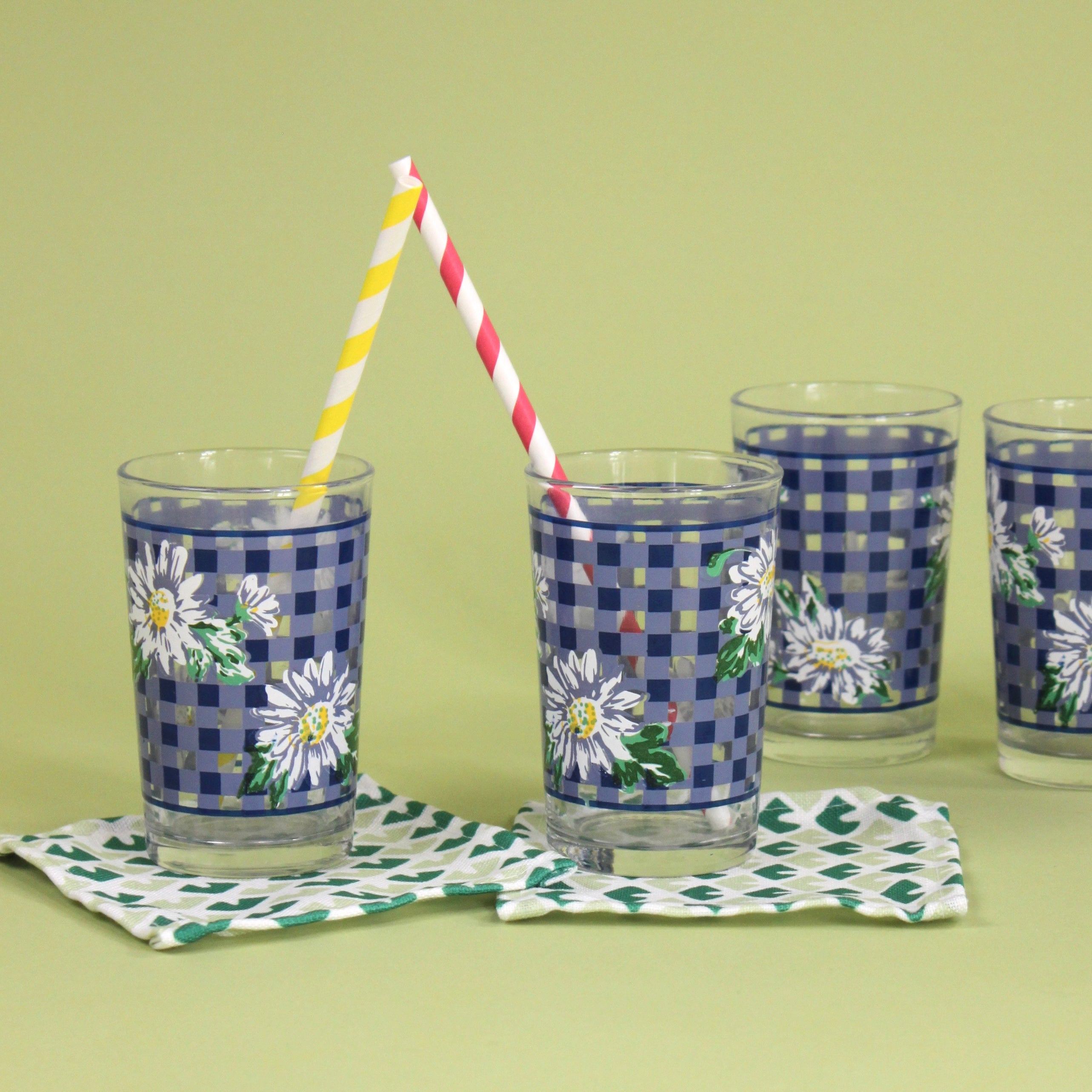 vintage drinking glasses featuring a blue gingham and daisy pattern. 