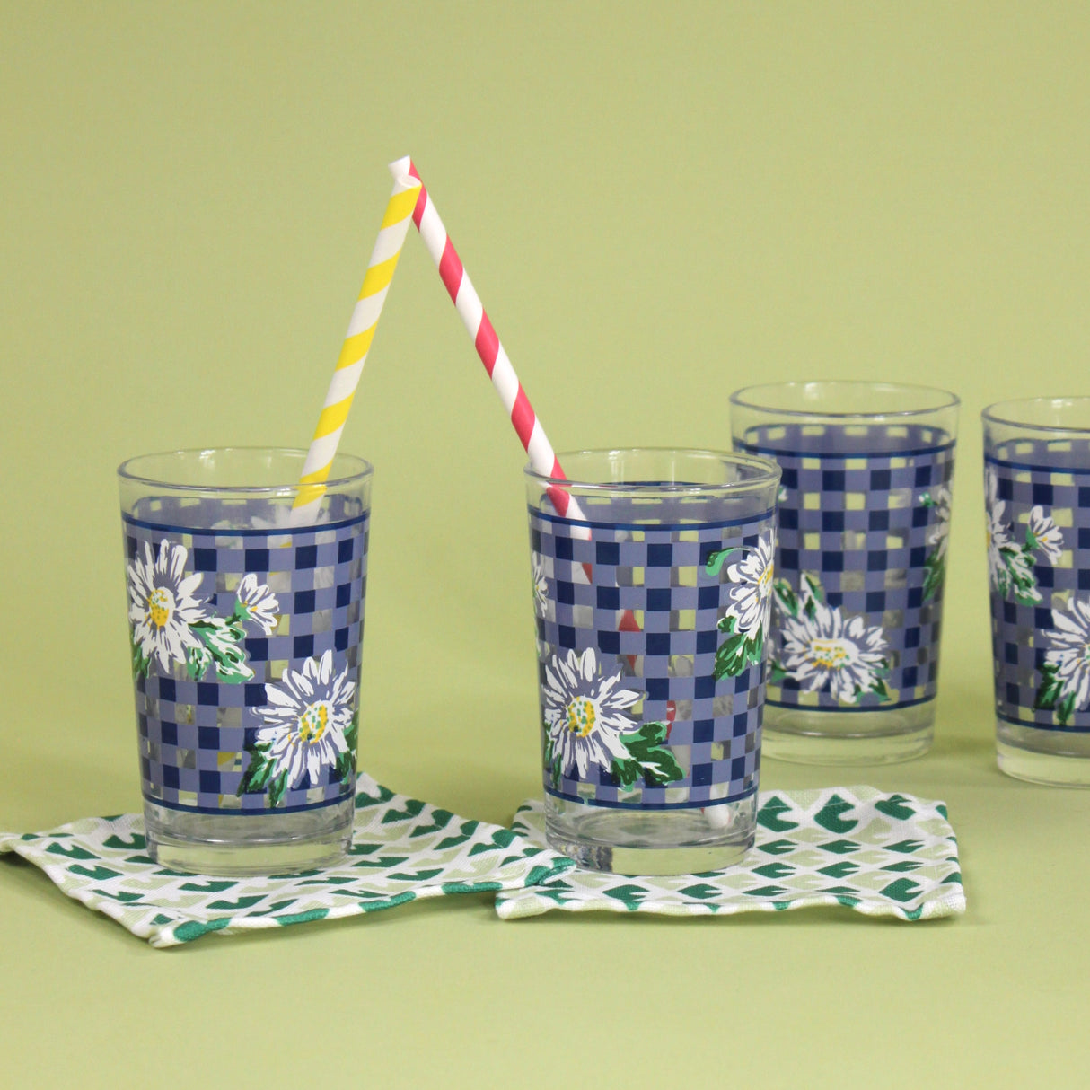 vintage drinking glasses featuring a blue gingham and daisy pattern. 