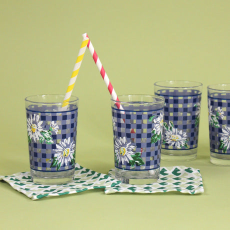 vintage drinking glasses featuring a blue gingham and daisy pattern. 