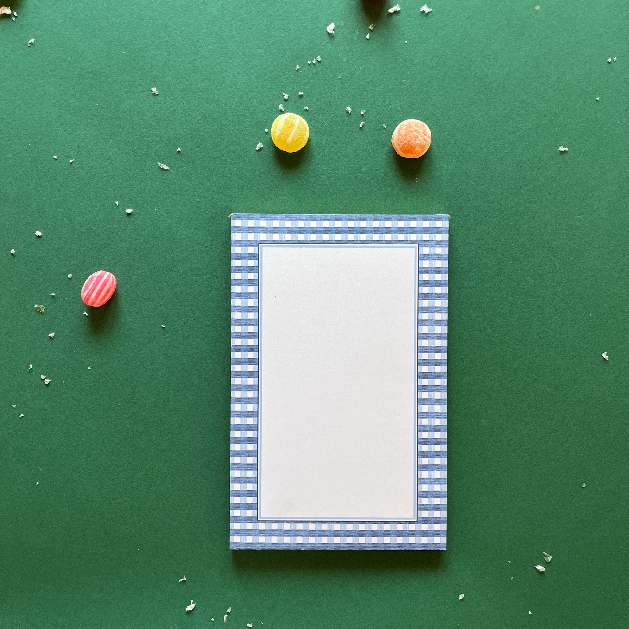 a luxury notepad with a blue gingham border