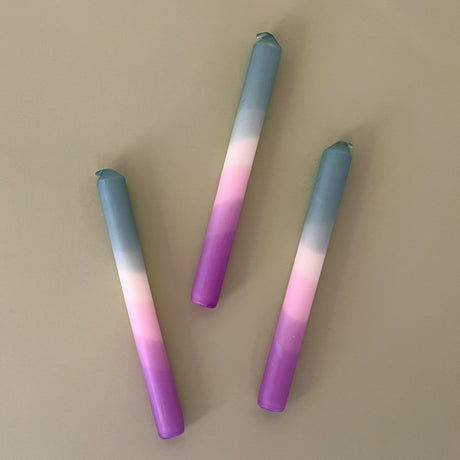 three taper candles in mixed shades of blue and purple