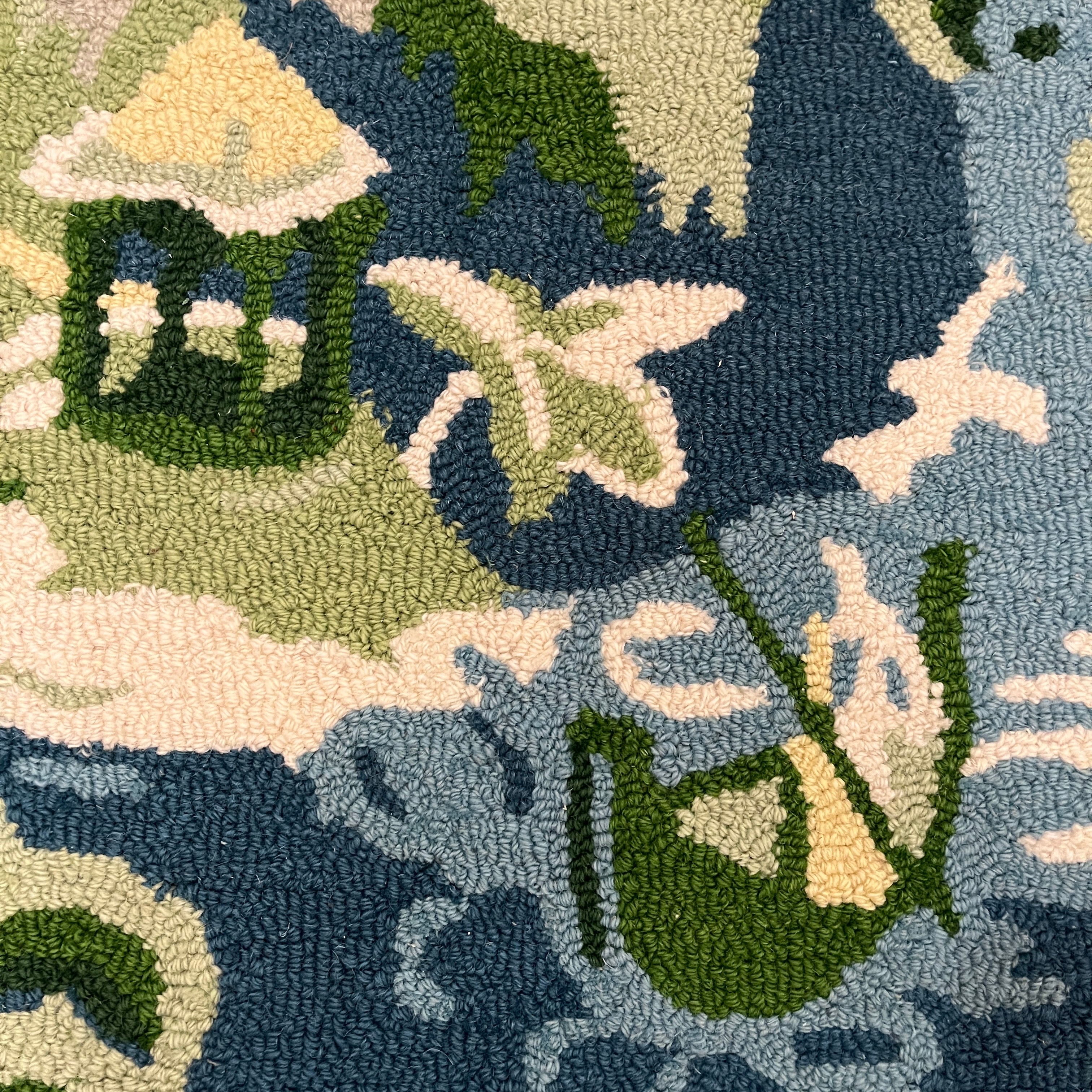 a close up of the boatman on a blue and green chinoiserie rug from madcap cottage.