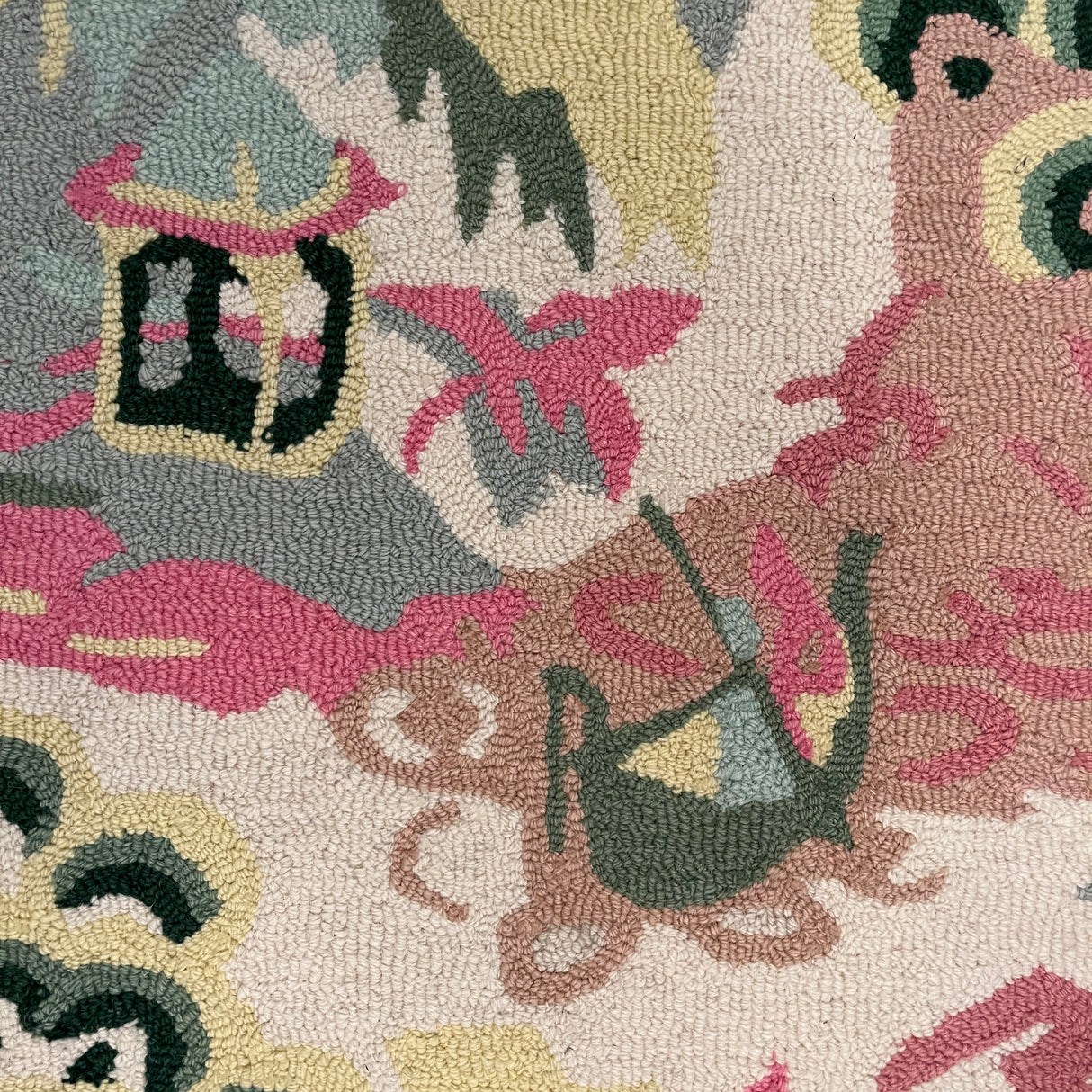 a close up of the boatman on an Old Peking pink and green rug with chinoiserie motifs from madcap cottage