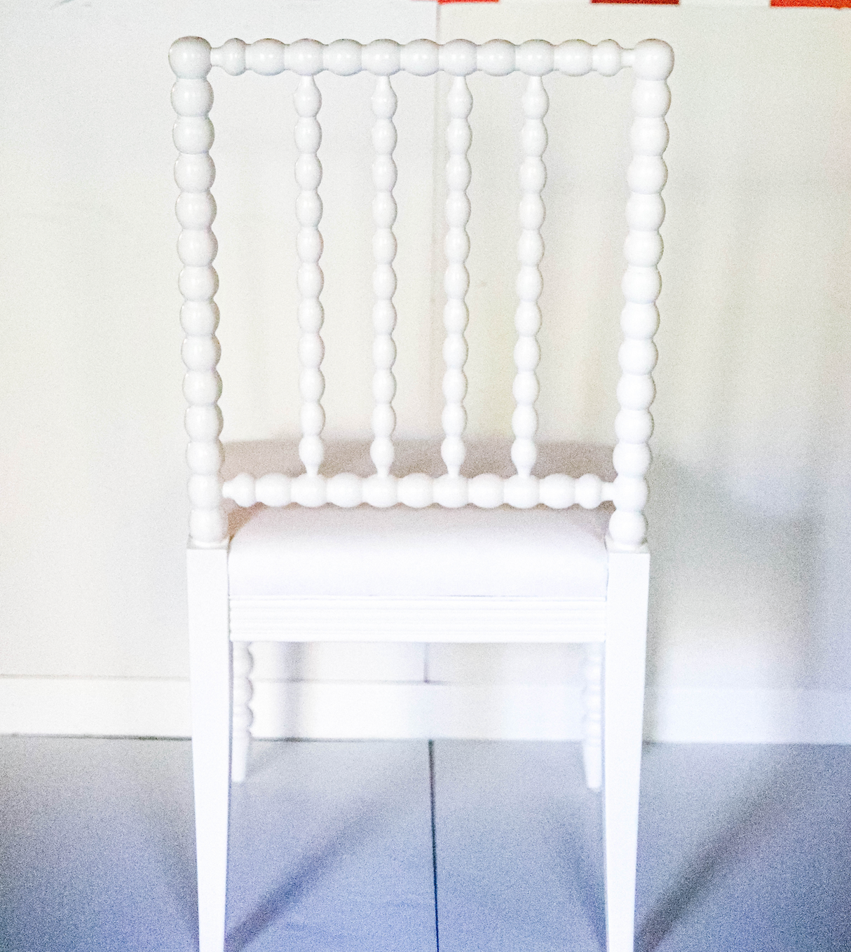 the back view of a white bobbin chair