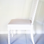a side view of a white bobbin chair