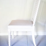 a side view of a white bobbin chair