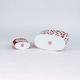 bottom of 2 madcap Cottage caddies with red abstract patterns on a white background