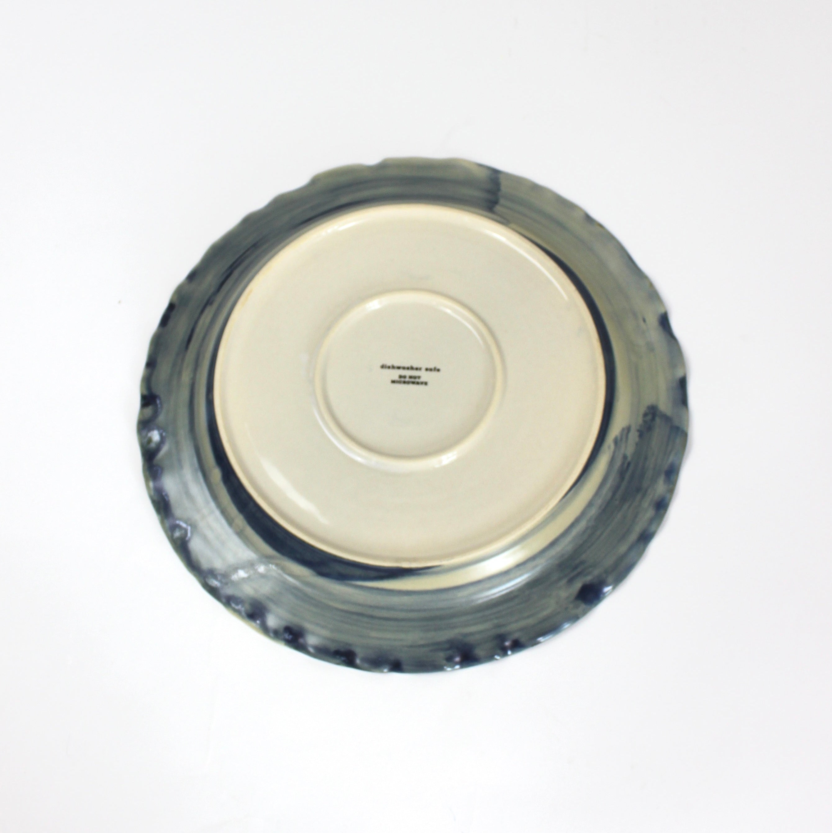 the underside of a glazed blue ceramic dinner plate from madcap cottage