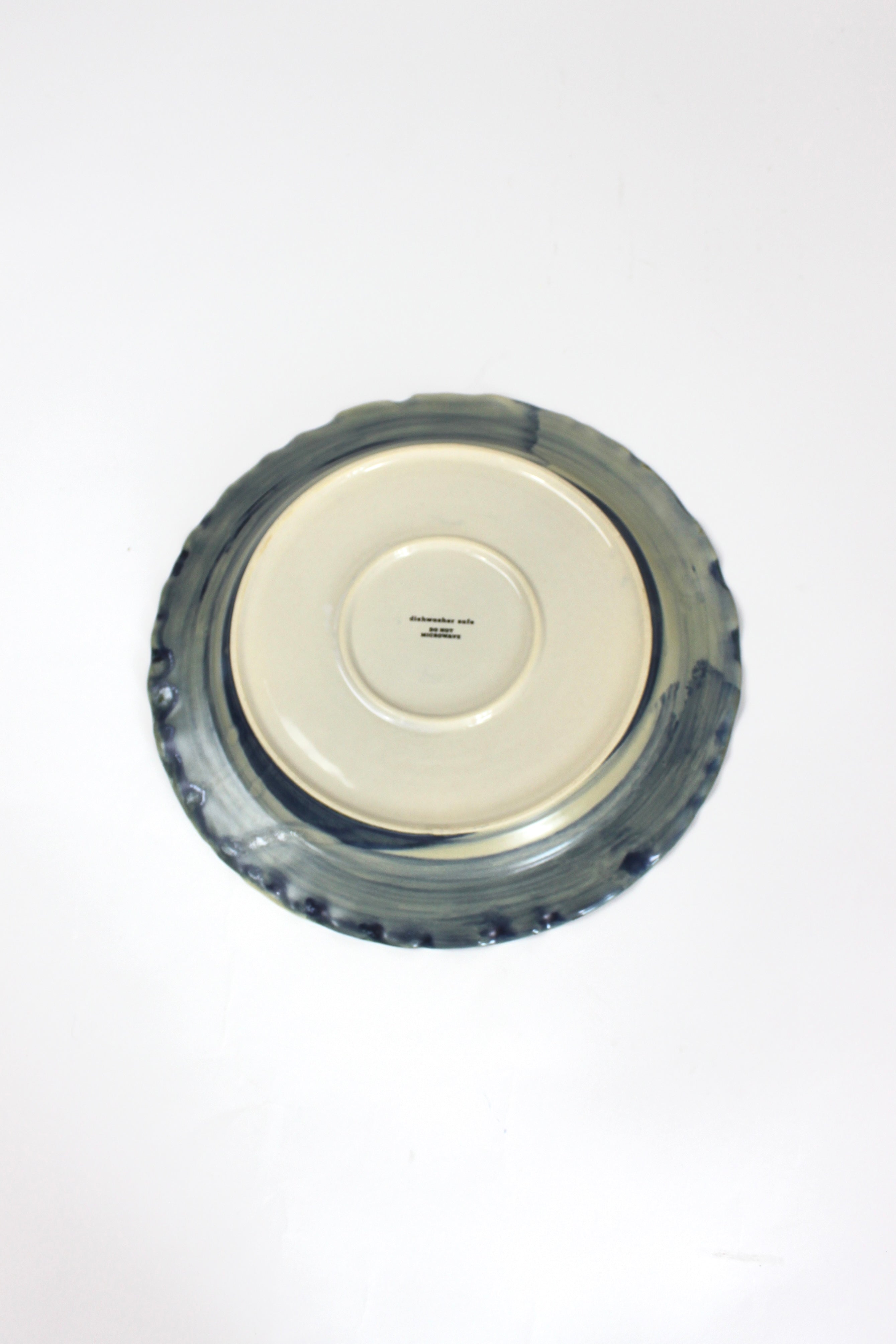the underside of a glazed blue ceramic dinner plate from madcap cottage