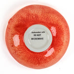 grapefruit shaped ceramic bowls with a textured surface on a white background