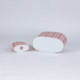 bottom of 2 madcap Cottage caddies with red abstract patterns on a white background