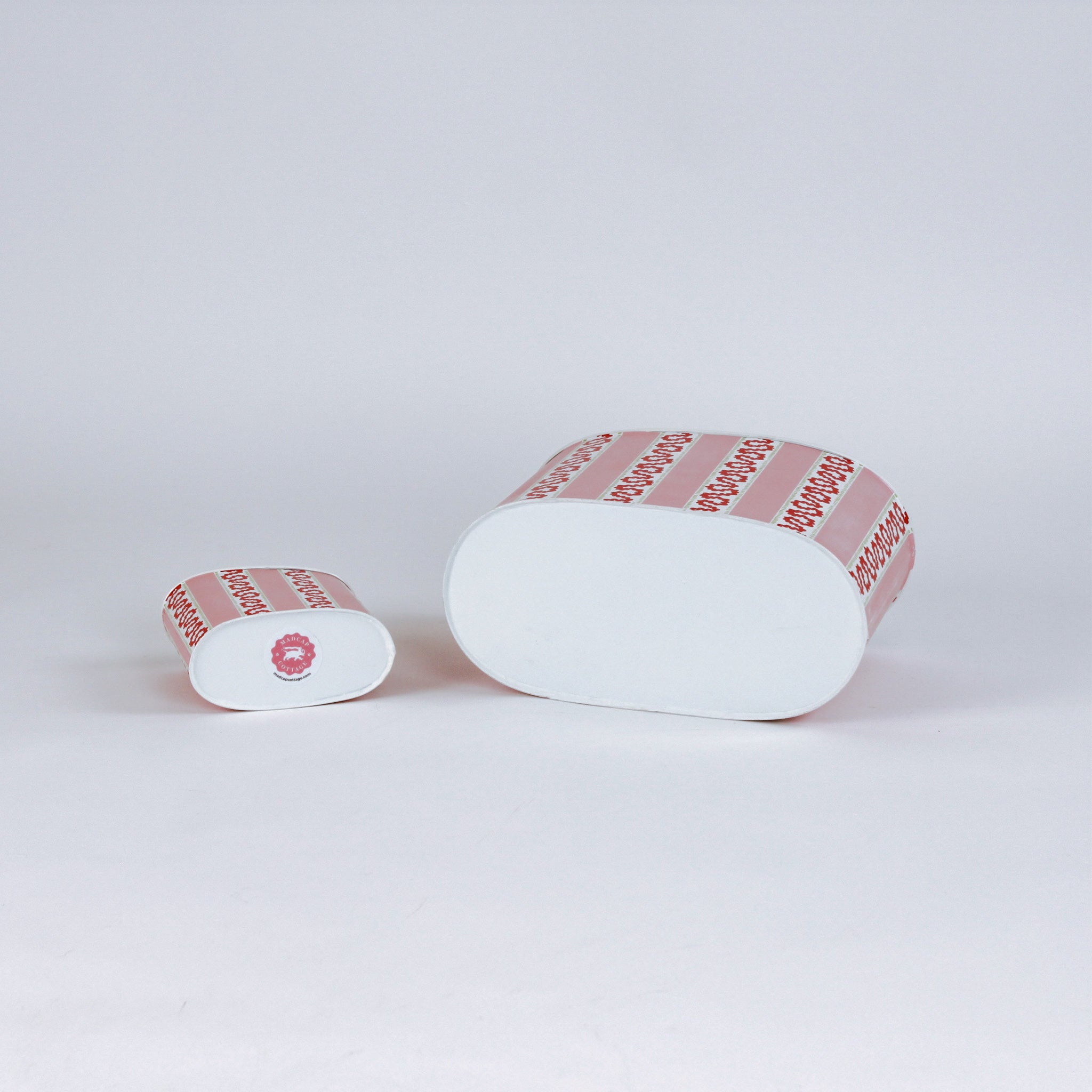 bottom of 2 madcap Cottage caddies with red abstract patterns on a white background