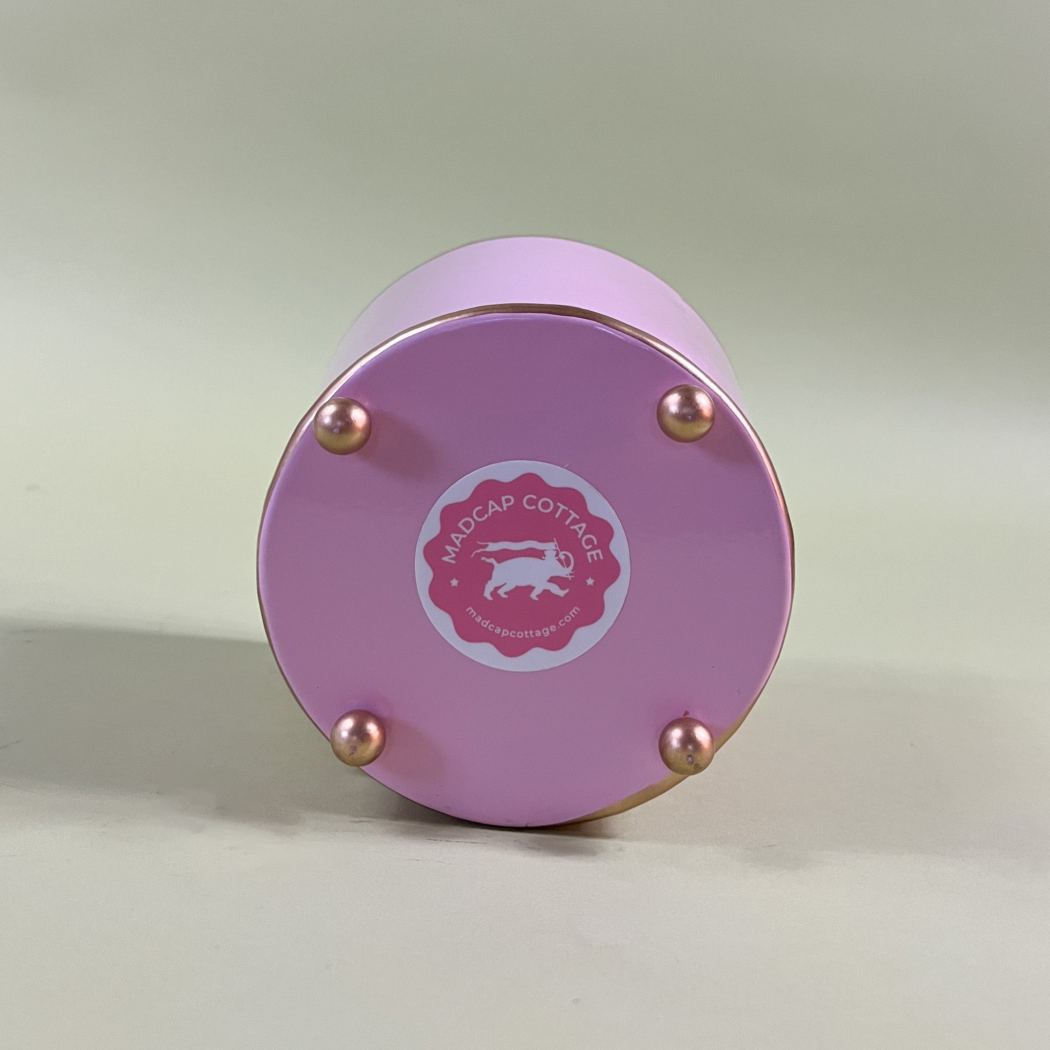 bottom of a pink tole cachepot with a pink madcap cottage sticker