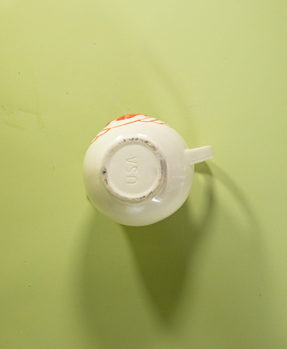 the bottom of a white vintage strawberry pitcher with text that reads USA