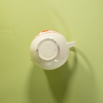 the bottom of a white vintage strawberry pitcher with text that reads USA