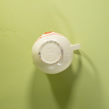 the bottom of a white vintage strawberry pitcher with text that reads USA