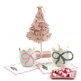Decorative Christmas tree with two mugs and candy on a white background