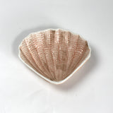 A small brown ceramic shell bowl