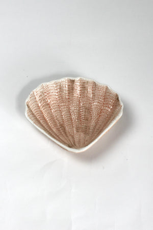 A small brown ceramic shell bowl
