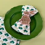 old jaipur green dinner napkin with bunny napkin ring on a plate