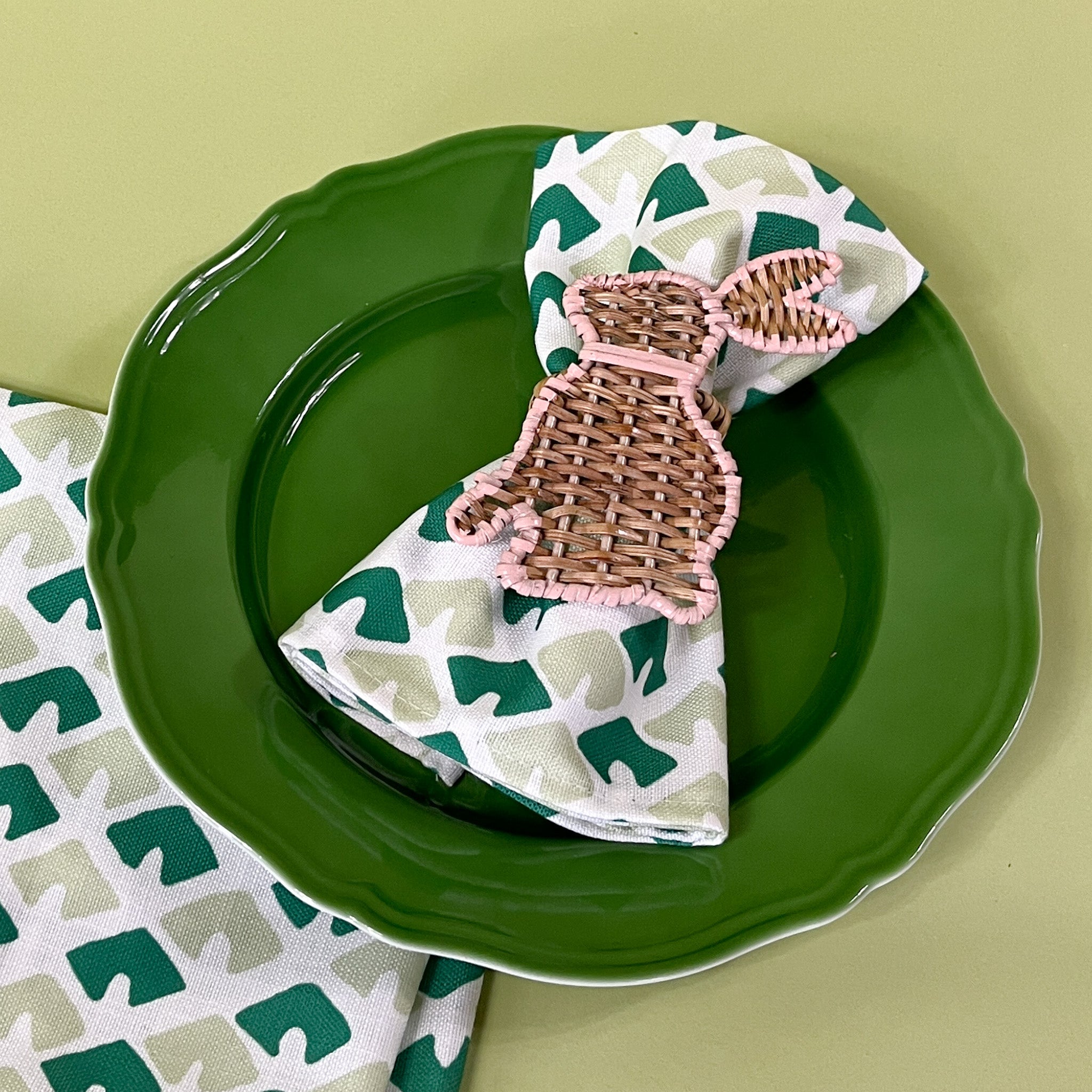 old jaipur green dinner napkin with bunny napkin ring on a plate