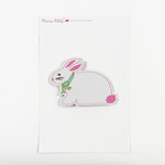 a bunny-shaped spring paper place card designed by Madcap Cottage with a ribbon on it's neck on a white background