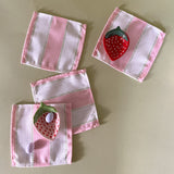 cabana boy pink and white stripe cloth cocktail napkins with strawberry accent dishes