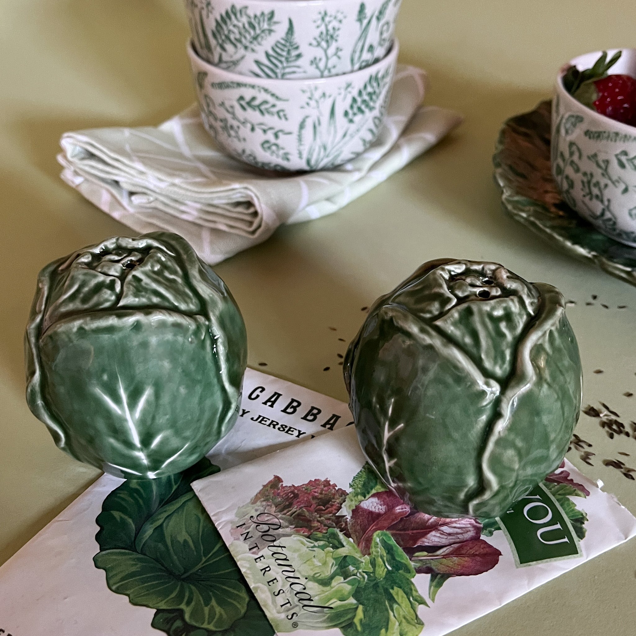 a pair of ceramic cabbage salt and pepper shakers.