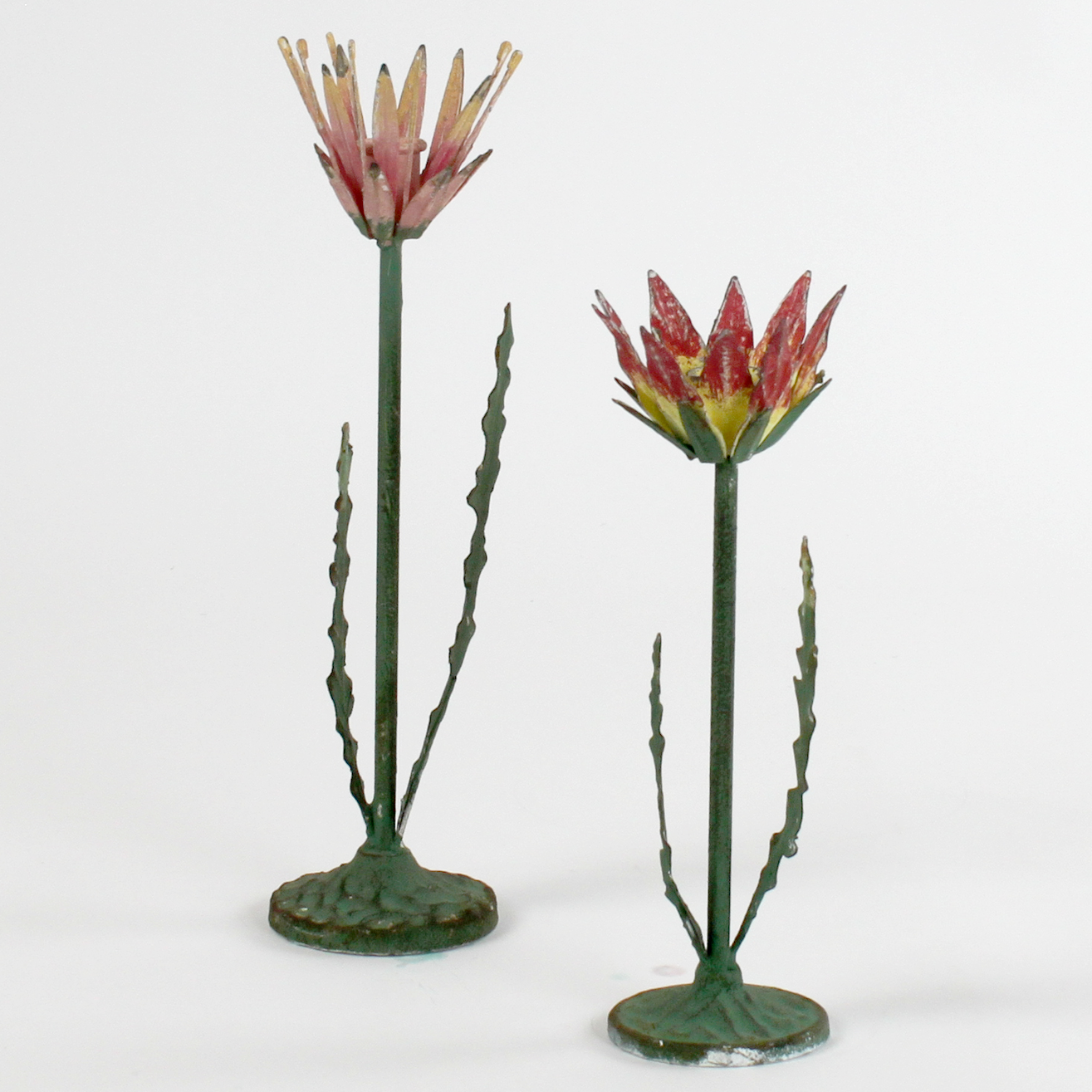 Two decorative metal Red Lotus flower sculptures on a white background
