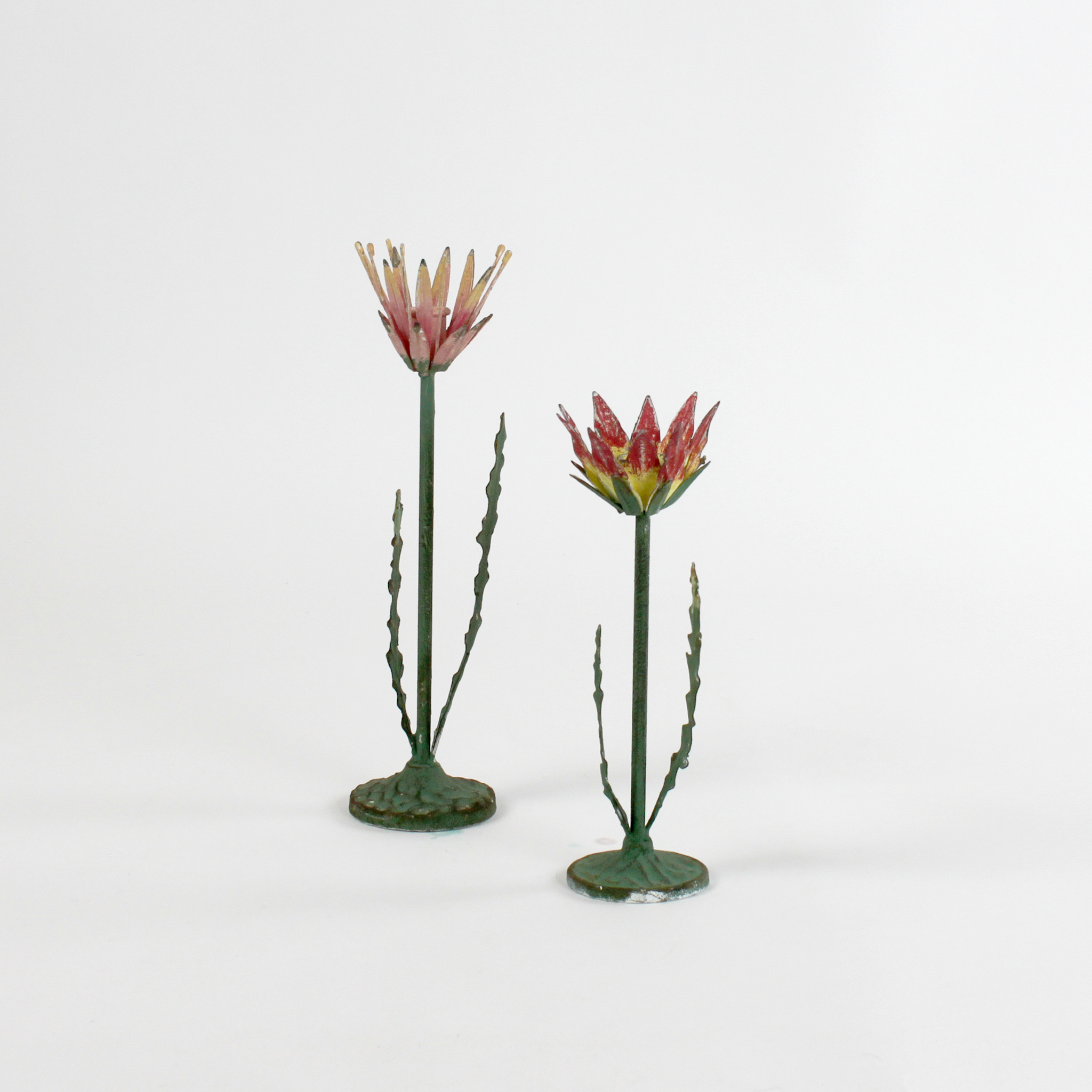 Two decorative metal Red Lotus flower sculptures on a white background