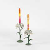 Two decorative metal hydrangea flower sculptures with colorful candles on a white background